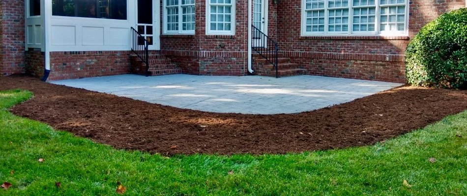 Backyard in Knightdale, NC, with patio surrounded by a mulched area.
