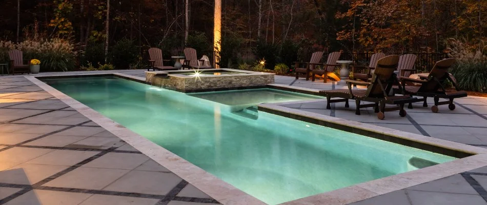 Rectangular pool in Cary, NC, with brown chairs.